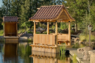 Inspiration for a large asian full sun backyard stone water fountain landscape in Other for summer.