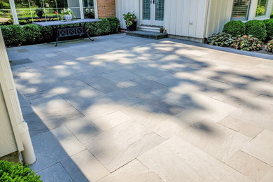 Country backyard stone patio photo in Chicago