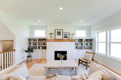 Example of a beach style formal living room design in Minneapolis with blue walls, a standard fireplace, a stone fireplace and a wall-mounted tv