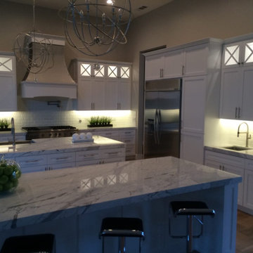Large White Kitchen with Double Islands and Illuminated Cabinets