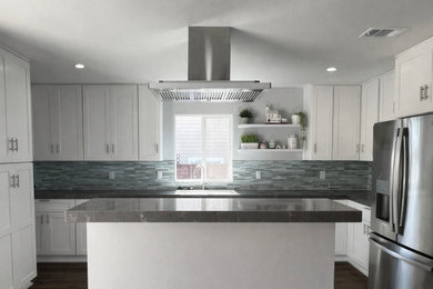 Inspiration for a contemporary eat-in kitchen remodel in Los Angeles with shaker cabinets, white cabinets and an island
