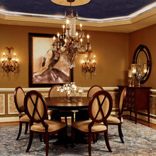Wallpaper or fabric inside of wainscoting frames.