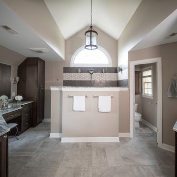 Vaulted Ceiling Primary Bathroom with Dual Vanities and Privacy Wall