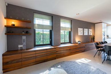 Example of a trendy concrete floor and gray floor living room design in Amsterdam with gray walls