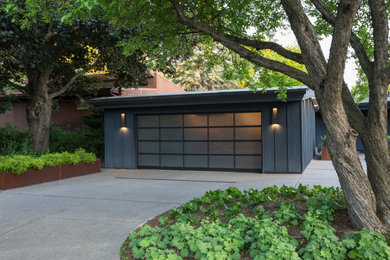 Garage - mid-sized modern attached two-car garage idea in Minneapolis