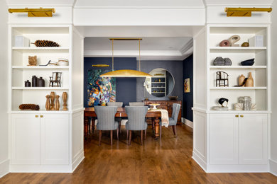 Inspiration for a mid-sized contemporary medium tone wood floor, brown floor, coffered ceiling and wallpaper enclosed dining room remodel in Vancouver with blue walls