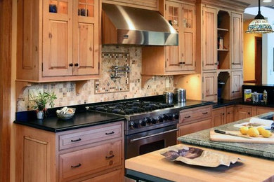 Mid-sized l-shaped light wood floor eat-in kitchen photo in DC Metro with light wood cabinets, granite countertops, beige backsplash, ceramic backsplash, stainless steel appliances and an island