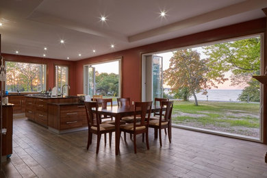 Open concept kitchen - large traditional l-shaped dark wood floor and brown floor open concept kitchen idea in Toronto with flat-panel cabinets, dark wood cabinets, quartz countertops, stainless steel appliances and an island