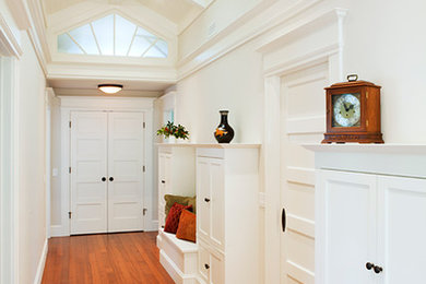 Hallway - large transitional medium tone wood floor and brown floor hallway idea in San Francisco with white walls