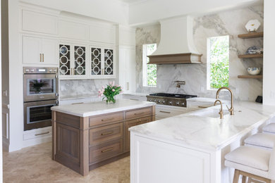 Example of a transitional u-shaped beige floor kitchen design in Other with an undermount sink, recessed-panel cabinets, white cabinets, gray backsplash, stone slab backsplash, stainless steel appliances, an island and white countertops