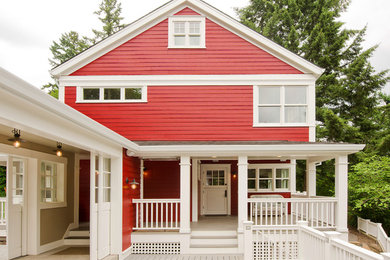 Photo of a traditional two-storey red exterior in Portland with wood siding.