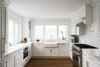 Elegant u-shaped eat-in kitchen photo in Providence with marble countertops, marble backsplash, stainless steel appliances and no island