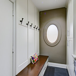 Inspiration for a small galley separated utility room in Toronto with a belfast sink, shaker cabinets, white cabinets, engineered stone countertops, grey walls and blue floors.