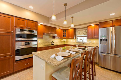 Example of a large classic l-shaped ceramic tile eat-in kitchen design in Boston with a double-bowl sink, flat-panel cabinets, medium tone wood cabinets, quartz countertops, beige backsplash, ceramic backsplash, stainless steel appliances and an island