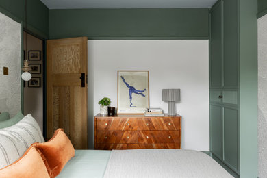Design ideas for a medium sized contemporary master bedroom in Hertfordshire with green walls.