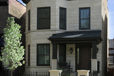 Inspiration for a traditional two-storey grey house exterior in Chicago with stone veneer, a flat roof and a mixed roof.