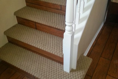 Mid-sized elegant carpeted straight wood railing staircase photo in San Diego with wooden risers