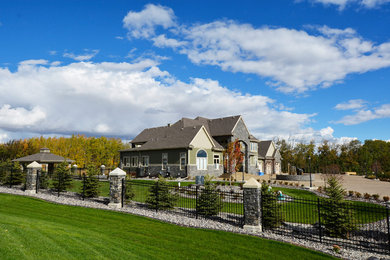 This is an example of a huge traditional full sun front yard concrete paver landscaping in Edmonton for summer.