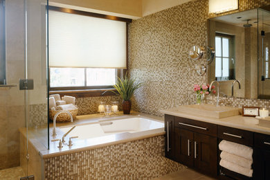 Photo of a contemporary bathroom in Denver with a vessel sink, dark wood cabinets, an undermount tub, brown tile and mosaic tile.