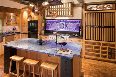 Large u-shaped enclosed kitchen photo in Los Angeles with light wood cabinets, granite countertops and an island