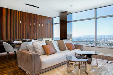 Living room - small modern medium tone wood floor, brown floor and wood wall living room idea in Los Angeles