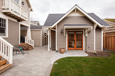 Mid-sized traditional beige one-story wood house exterior idea in Orange County with a hip roof and a shingle roof