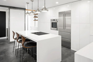 Inspiration for a modern l-shaped gray floor open concept kitchen remodel in Phoenix with an undermount sink, flat-panel cabinets, white cabinets, quartz countertops, white backsplash, quartz backsplash, stainless steel appliances, an island and white countertops
