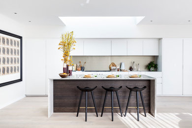 Inspiration for a mid-sized contemporary open plan kitchen in London with with island.