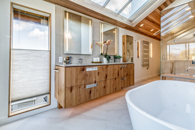 Example of a large trendy master gray tile and cement tile concrete floor and gray floor bathroom design in Vancouver with flat-panel cabinets, medium tone wood cabinets, a one-piece toilet, white walls, an undermount sink, concrete countertops, a hinged shower door and gray countertops