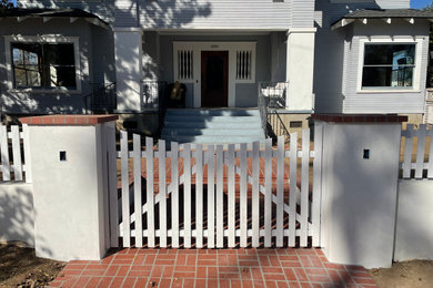 Design ideas for a mid-sized victorian full sun front yard brick and wood fence landscaping in San Diego for spring.