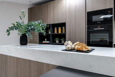 Photo of a modern kitchen in London with with island.