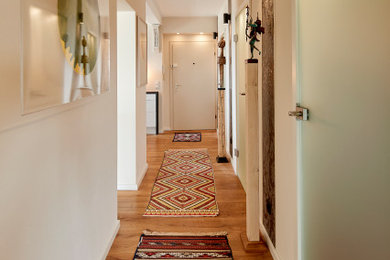 Inspiration for a contemporary hallway in Essen with beige walls and dark hardwood floors.