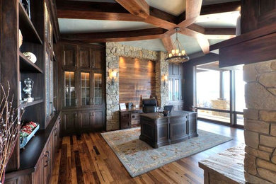 Mountain style freestanding desk brown floor home office photo in Other with a stone fireplace