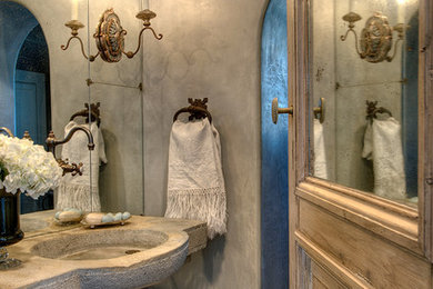 Mid-sized farmhouse 3/4 stone tile bathroom photo in Houston with a trough sink, solid surface countertops and blue walls