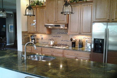Example of a transitional eat-in kitchen design in Seattle with an undermount sink, medium tone wood cabinets, beige backsplash and stainless steel appliances