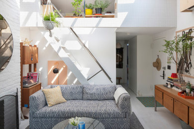Example of a small eclectic open concept beige floor living room design in New York with white walls, a standard fireplace and a brick fireplace