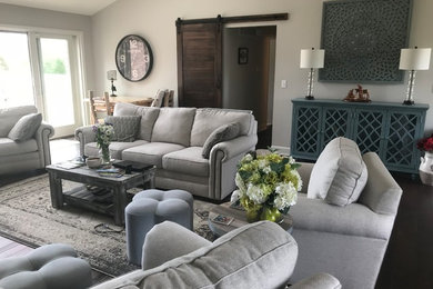 Family room - mid-sized craftsman open concept dark wood floor and brown floor family room idea in St Louis with gray walls, a corner fireplace, a stone fireplace and a wall-mounted tv