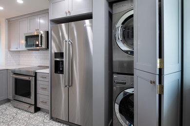 Inspiration for a small l-shaped green floor kitchen remodel in Miami with shaker cabinets, gray cabinets, quartzite countertops, white backsplash, ceramic backsplash, stainless steel appliances, a peninsula, white countertops and an undermount sink