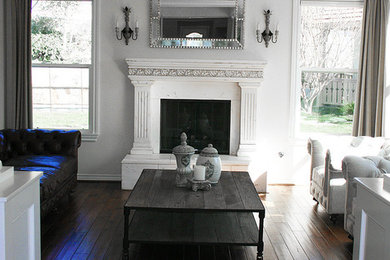 Example of a mid-sized classic formal and enclosed dark wood floor and brown floor living room design in Los Angeles with beige walls, a standard fireplace, a plaster fireplace and no tv