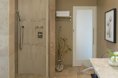 Example of a minimalist master stone tile and beige tile limestone floor doorless shower design in New York with beige walls and marble countertops