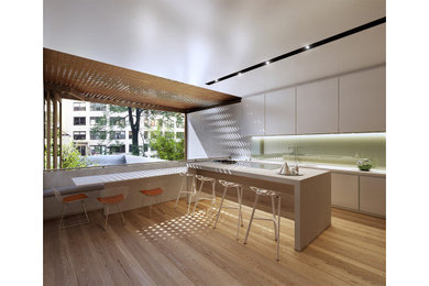 Example of a mid-sized trendy galley light wood floor open concept kitchen design in New York with a double-bowl sink, flat-panel cabinets, white cabinets, green backsplash, glass sheet backsplash, paneled appliances, an island and white countertops