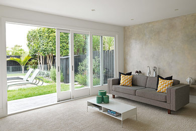 Transitional open concept carpeted living room photo in Auckland with beige walls