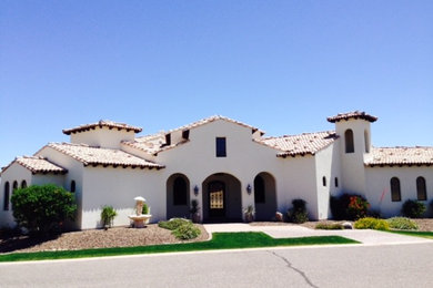 Large mediterranean white two-story exterior home idea in Phoenix