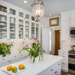 Large traditional kitchen pantry appliance - Inspiration for a large timeless u-shaped kitchen pantry remodel in Hawaii with a double-bowl sink, shaker cabinets, white cabinets, white backsplash, stainless steel appliances, an island and subway tile backsplash