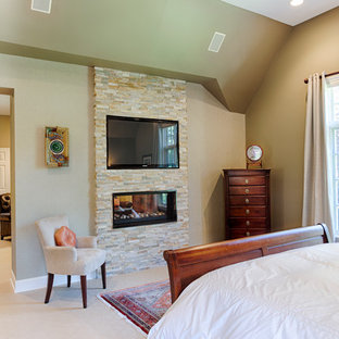 Idee per una grande camera matrimoniale etnica con pareti grigie, moquette, camino bifacciale e cornice del camino in pietra