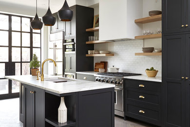 Inspiration for a mid-sized transitional single-wall separate kitchen in Toronto with an undermount sink, shaker cabinets, white splashback, subway tile splashback, stainless steel appliances, medium hardwood floors, with island, marble benchtops, brown floor and white benchtop.
