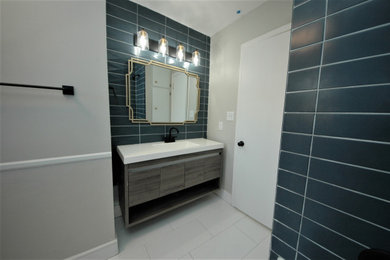Example of a mid-sized minimalist kids' blue tile and ceramic tile white floor and single-sink drop-in bathtub design in Other with distressed cabinets, gray walls, an integrated sink, quartz countertops, white countertops and a floating vanity