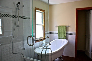 Inspiration for a mid-sized midcentury master bathroom in Denver with beaded inset cabinets, white cabinets, a claw-foot tub, a corner shower, a two-piece toilet, black and white tile, ceramic tile, yellow walls, porcelain floors, an undermount sink, granite benchtops and a hinged shower door.