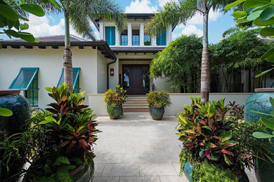 This is an example of an expansive transitional two-storey stucco white exterior in Miami.