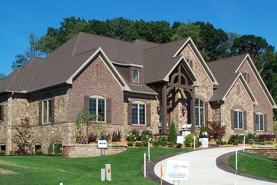 Large rustic three-story mixed siding exterior home idea in Cleveland with a hip roof